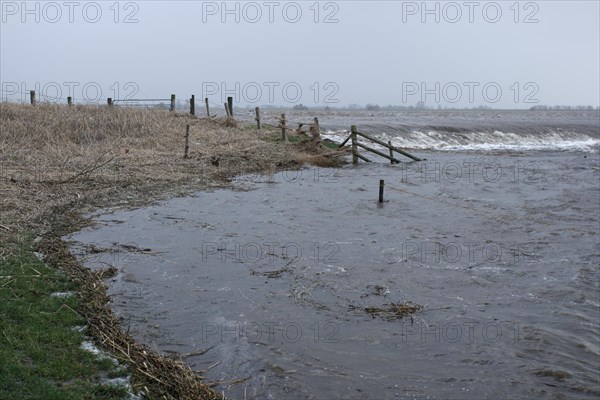 Overtopping of the dike during a storm surge on the Lower Weser island of Strohauser Plate