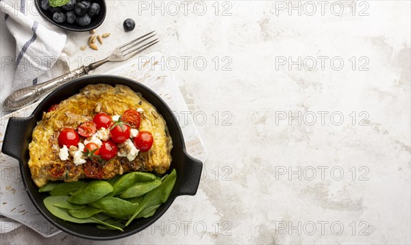 Omelette with cheese tomatoes marble copy space