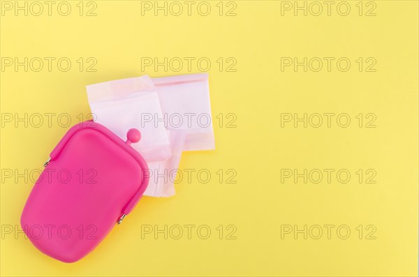 Pink purse with wrapped sanitary napkins