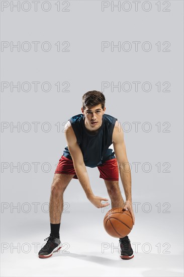 Man playing basketball alone