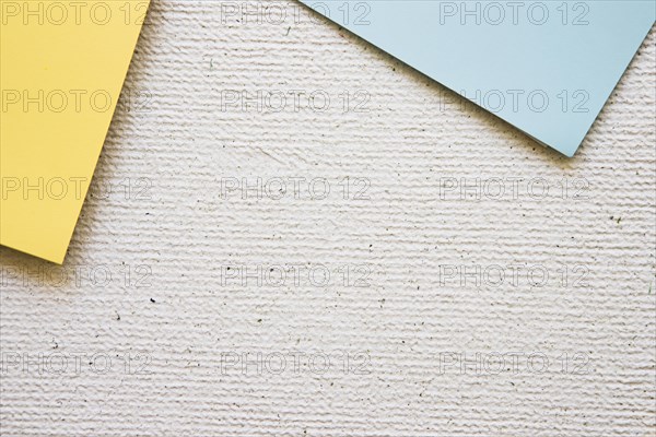 Overhead view grey yellow cardboard papers concrete background