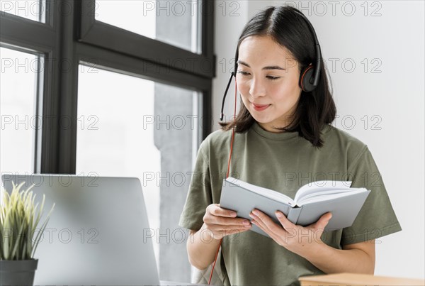 Woman with headset having video call laptop_3