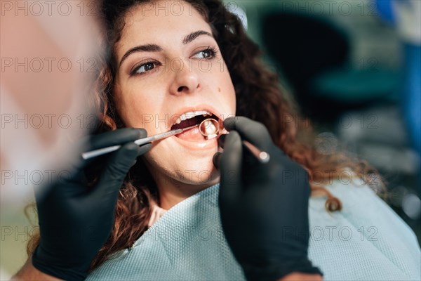 Close up woman getting check up dentist