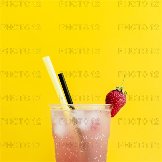 Misted glass cocktail with strawberry straws