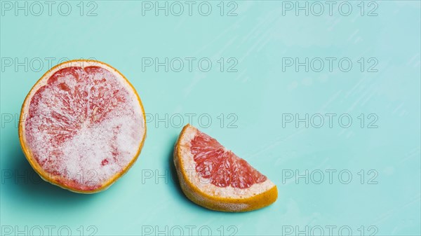 Frozen grapefruit turquoise background