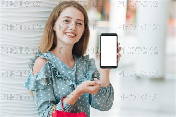 Happy girl showing her phone