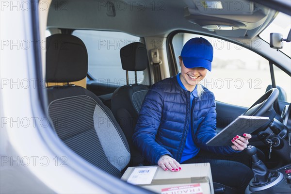Delivery girl with tablet car