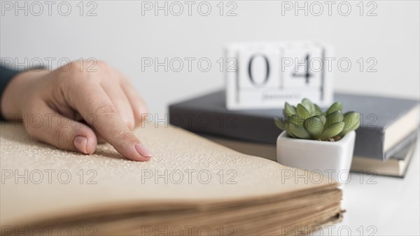 Close up hand reading old book