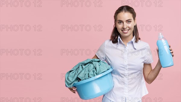 Woman holding laundry basket detergent