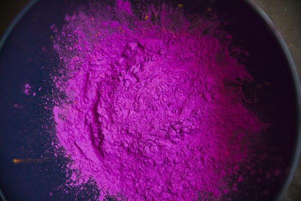 Overhead view pink color powder inside bowl
