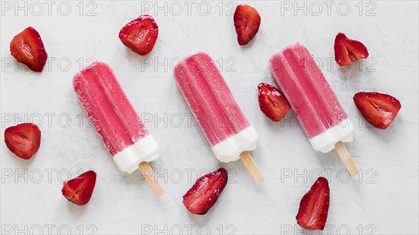 Top view yummy popsicles with strawberry