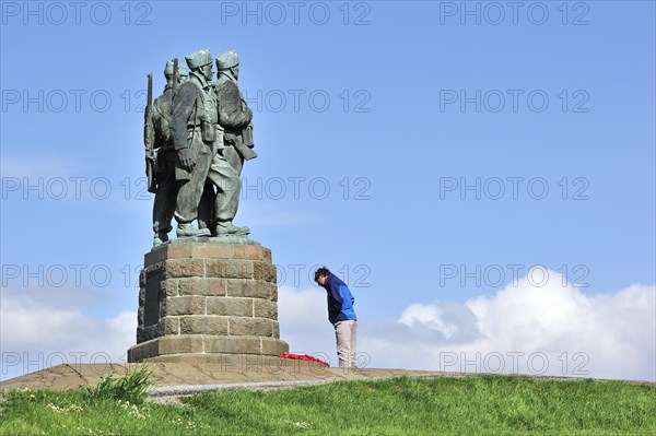 Tourists taking pictures in front of the Commando Memorial