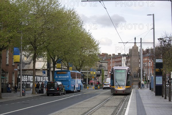 A Luas tram in the city centre with other vehicles visible too. Dublin