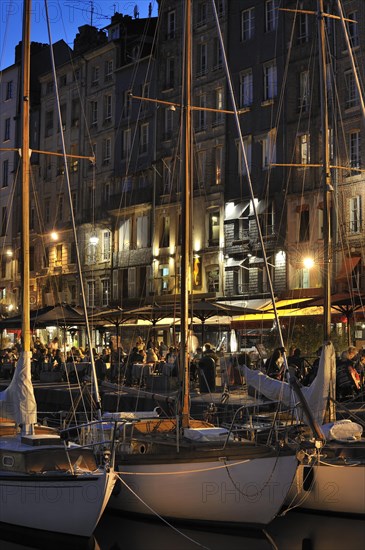 Sailing boats and tourists at pavement cafes