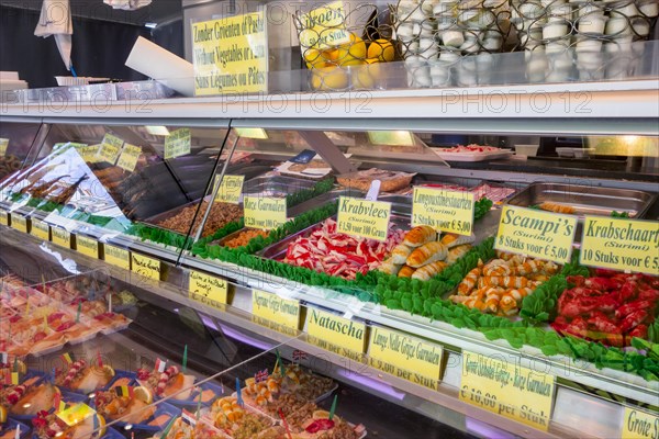 Counter with fresh seafood and snacks on display at fish stall along the Visserskaai in the city Ostend