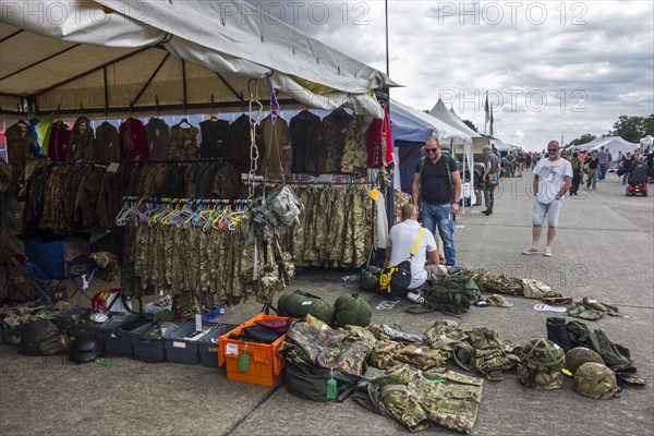 Military uniforms and battle dresses for sale in booth at militaria fair