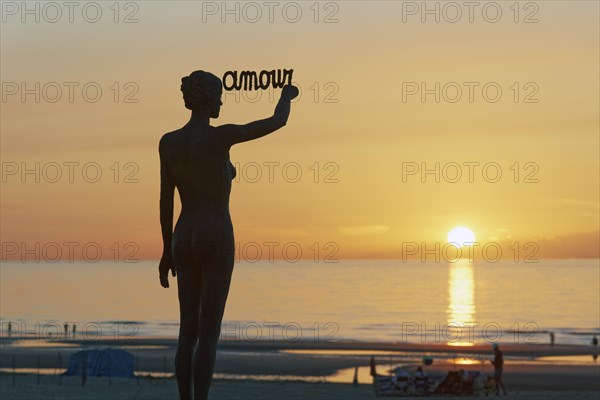 Woman writing French word Amour