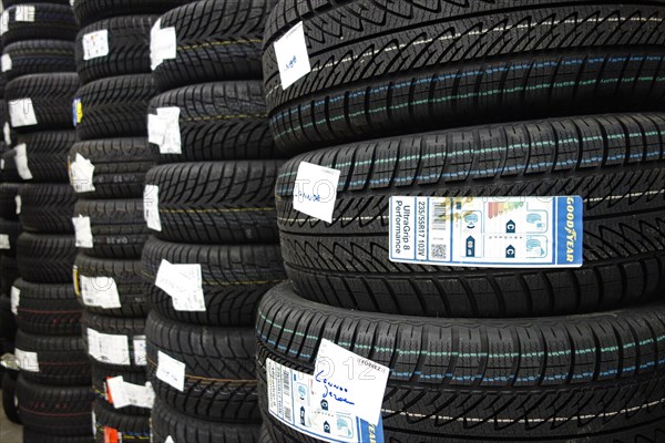 Piles of new winter tires snow tyres stored in tire centre