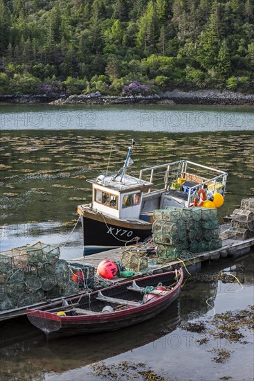 Moored small fishing boat and lobster pots