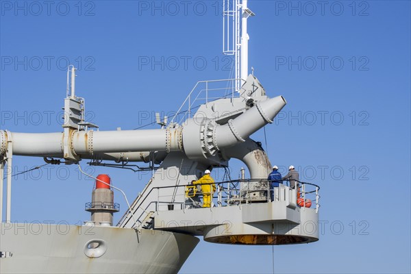 Workers on bow connection platform of trailing suction hopper dredger Alexander von Humboldt from Dredging and Marine Works Jan De Nul