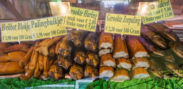 Counter with smoked fish and conger eels on display at fish stall along the Visserskaai in the city Ostend