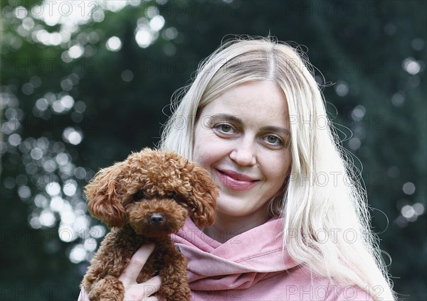 Young woman with Toy Poodle