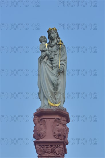 Madonna figure with baby Jesus and golden cross
