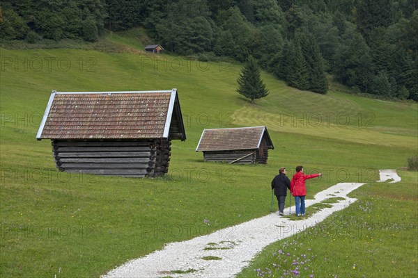 Tourists walking past wooden huts