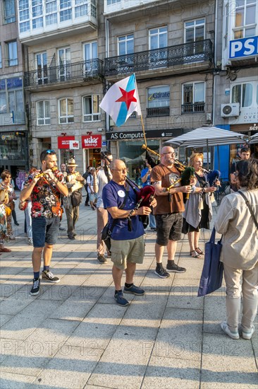 Bagpipe playing musicians BNG political party election campaign in plaza Praza Porto do Sol