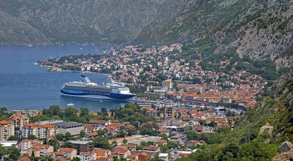 View over the city Kotor and cruise ship moored in the Mediterranean port on the Bay of Kotor