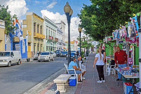 Street scene showing Spanish colonial houses and market stalls selling toys in the city Ponce