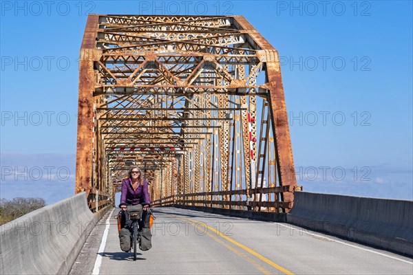 Cyclist and 1929 Chef Menteur Pass Bridge between New Orleans and Slidell on eastern side of Lake Pontchartrain