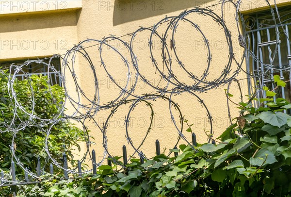 Razor wire fencing security fence on property wall