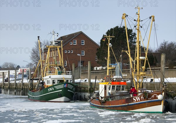 Fishing boats in the Wyk auf Foehr harbour in winter