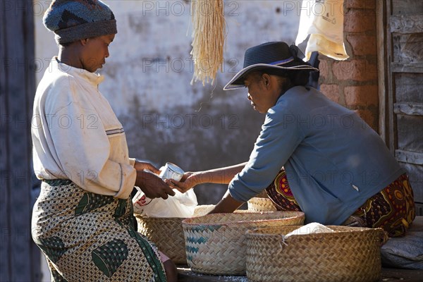 Malagasy woman buying groceries ant weekly market in the city Ambalavao