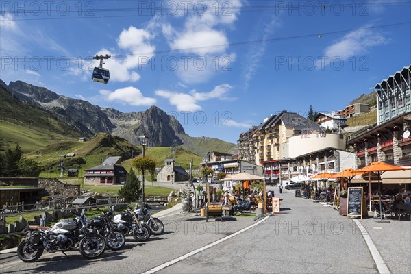 Parked motorbikes and tourists at pavement cafes