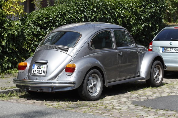 Silver VW Beetle parked on the street