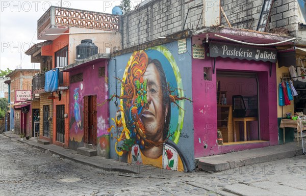 Mural painted on wall pf pasteleria shop on corner of street Tepoztlan