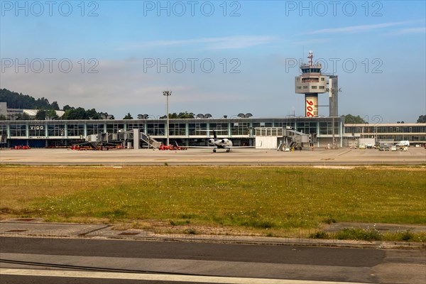 View through plane window of airport terminal buildings at Vigo