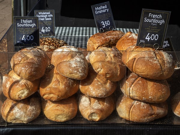 Fresh loaves of artisan bread on sale at street market stall