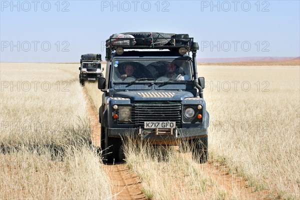 Off-road four-wheel drive vehicles driving on savanna track in Namibia