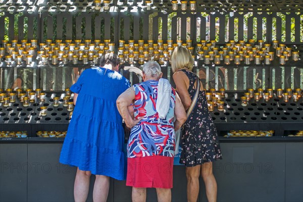 Elderly pilgrims burning candles at the Basilica of Our Lady of Scherpenheuvel