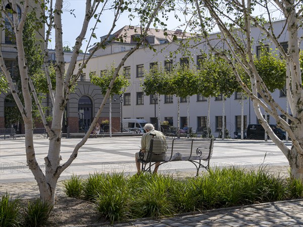 Senior sitting on a bench in the former parcel yard