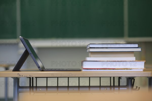 A digital device and books in a classroom as schools prepare for a return to teaching in September. Bavaria