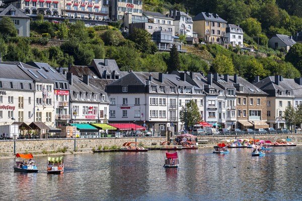 Paddle boats with tourists on the Semois river in the city Bouillon in summer
