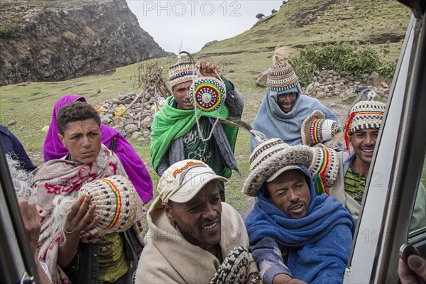 Group of local black people selling souvenirs to tourists along the road to Lalibela
