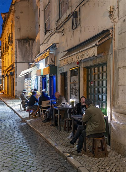 Outdoor restaurant in Alfama by night