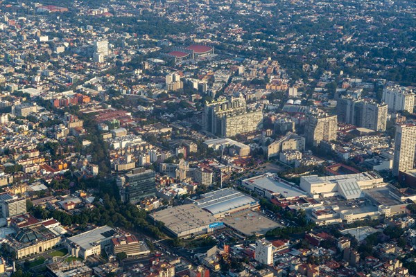Oblique angle aerial view through plane window over Universidad district