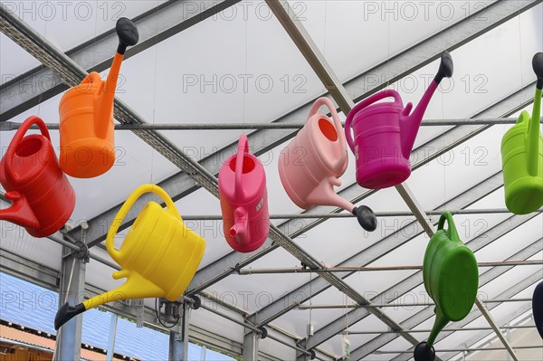 Colourful watering cans in a garden centre