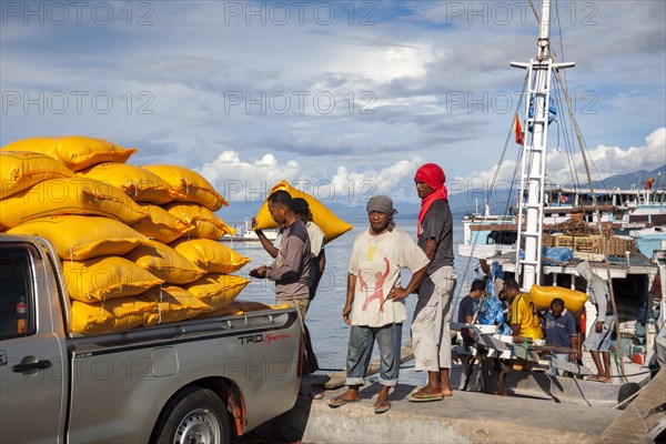 Loading bags from boat onto pickup truck